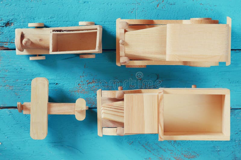 Old wooden transportation toys: train, car, track and plane on blue wooden background. vintage filtered and toned stock images Old wooden transportation toys: train, car, track and plane on blue wooden background. vintage filtered and toned stock images
