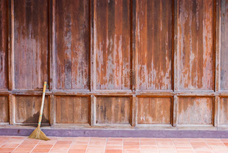 Old Wooden Wall with a Broom Ready for Cleaning Work Stock Image