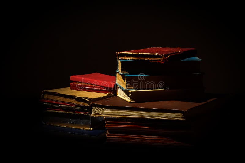 Old worn books on black