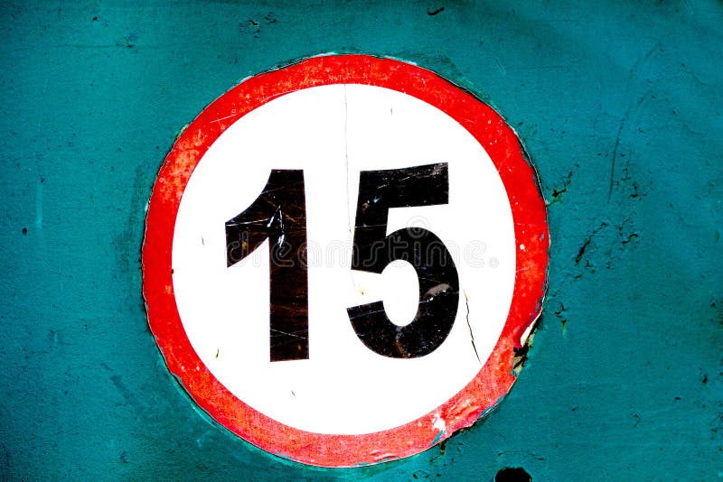 Old worn sign speed limit 15 sticker on board