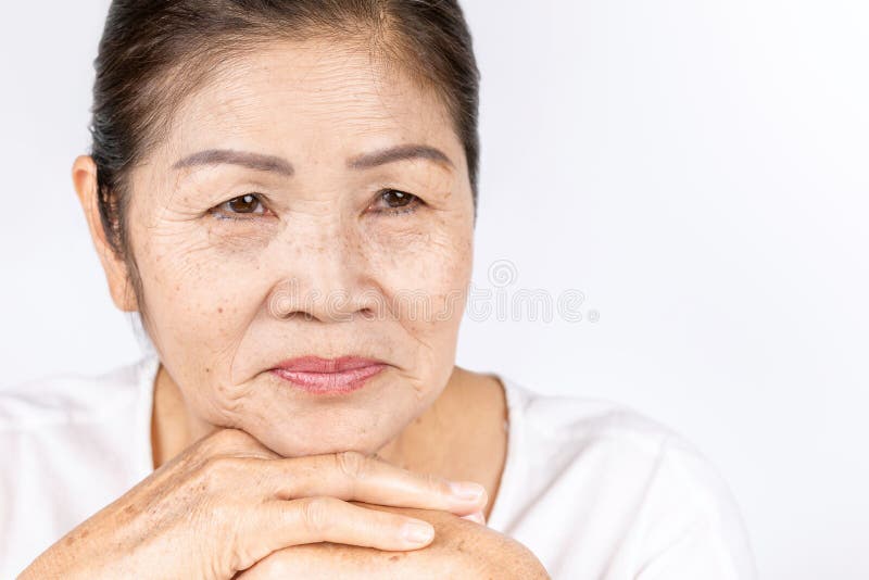 portrait of old Asian senior woman with wrinkle skin and black