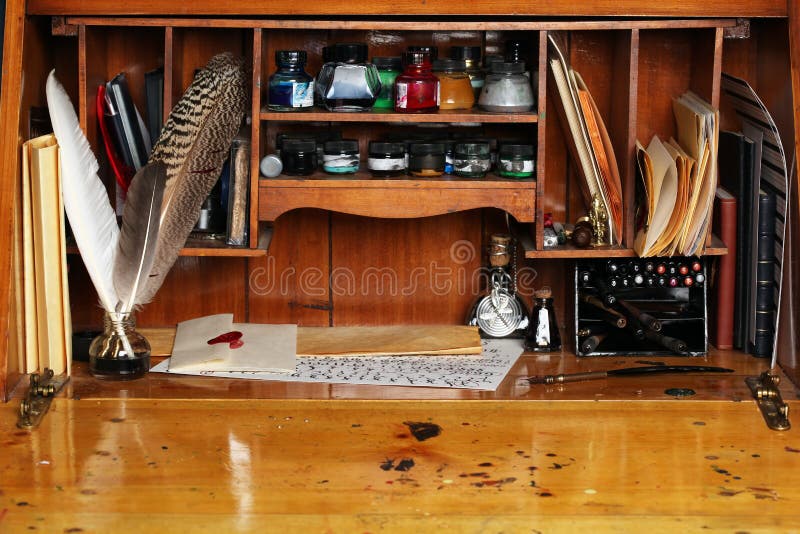 Old writing desk. Full of quills & inks for calligraphy royalty free stock images