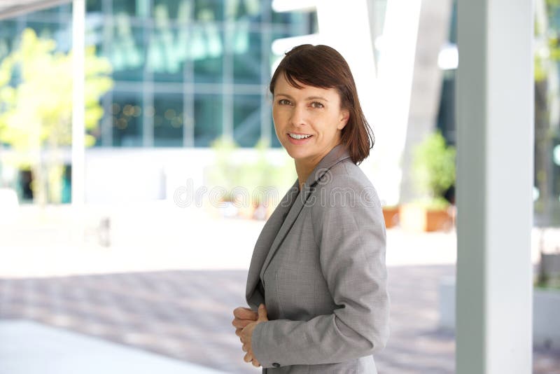 Older business woman smiling outdoors