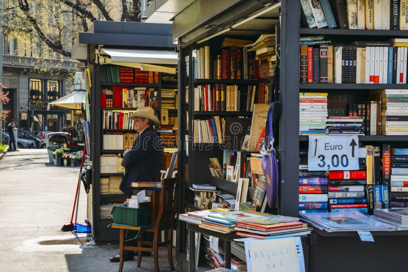 An older man with a cowboy hat sells books on the street stock photos An older man with a cowboy hat sells books on the street stock photos