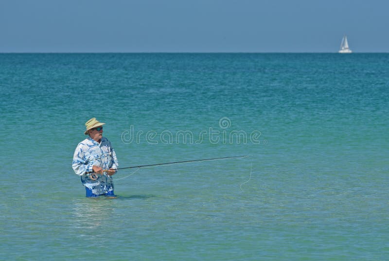 Older Man Fly Fishing in Ocean