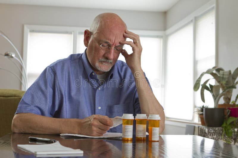 Older man with prescription medications, horizontal royalty free stock photography