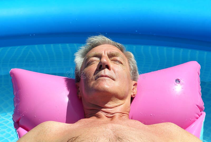 Older Man Sunbathing on a Lilo Stock Image photo picture