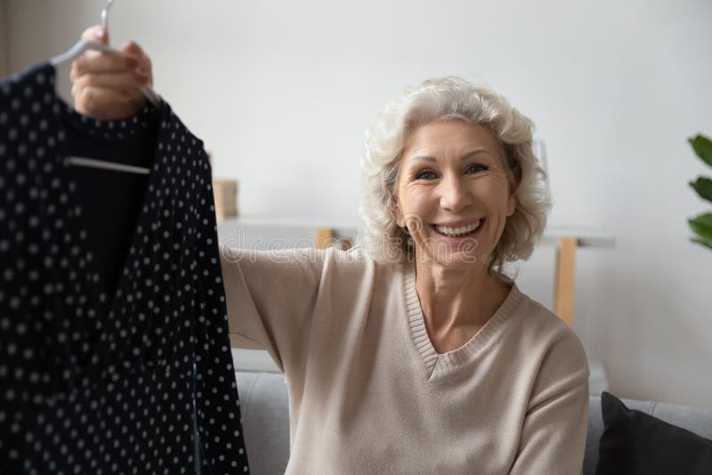 Older Mature Woman Blogger Demonstrating Purchased Jacket. Stock Image ...