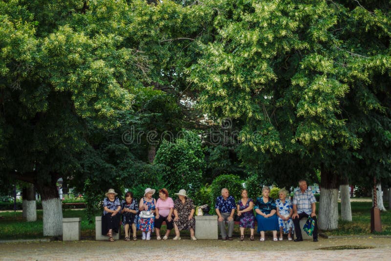 ARMAVIR, RUSSIA - JULE 02, 2016: Older people are sitting on a Park bench on a summer day. ARMAVIR, RUSSIA - JULE 02, 2016: Older people are sitting on a Park bench on a summer day