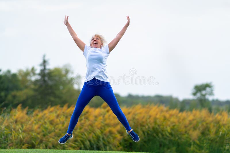 Woman jumping for joy with arms and legs spread