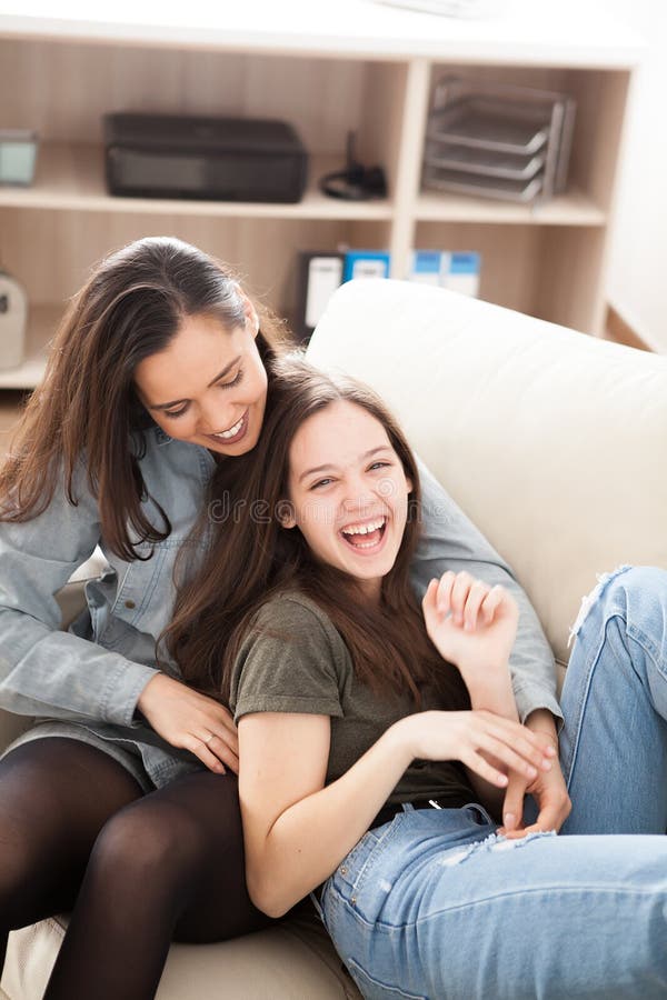 The Oldes Sister is Cuddling the Younger One Stock Photo - I