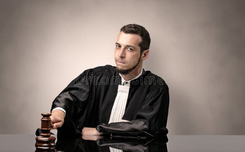 Oldscool young judge in gown. Young dashing judge in black gown making decision with no concept