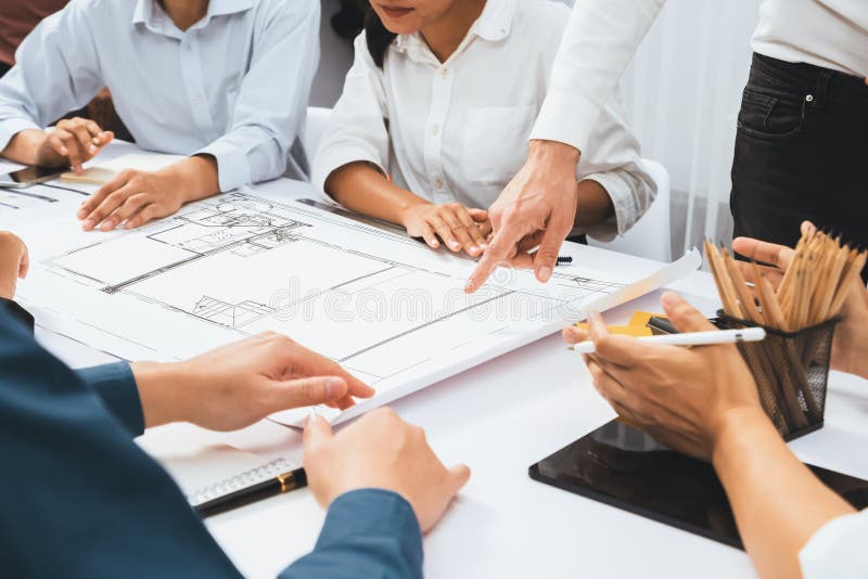 Diverse group of civil engineer and client working together on architectural project, reviewing construction plan and building blueprint at meeting table. Prudent. Diverse group of civil engineer and client working together on architectural project, reviewing construction plan and building blueprint at meeting table. Prudent