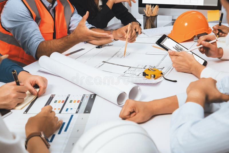 Diverse group of civil engineer and client working together on architectural project, reviewing construction plan and building blueprint at meeting table. Prudent. Diverse group of civil engineer and client working together on architectural project, reviewing construction plan and building blueprint at meeting table. Prudent