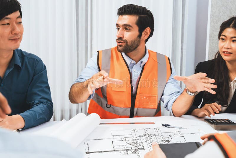 Diverse group of civil engineer and client working together on architectural project, reviewing construction plan and building blueprint at meeting table. Prudent. Diverse group of civil engineer and client working together on architectural project, reviewing construction plan and building blueprint at meeting table. Prudent