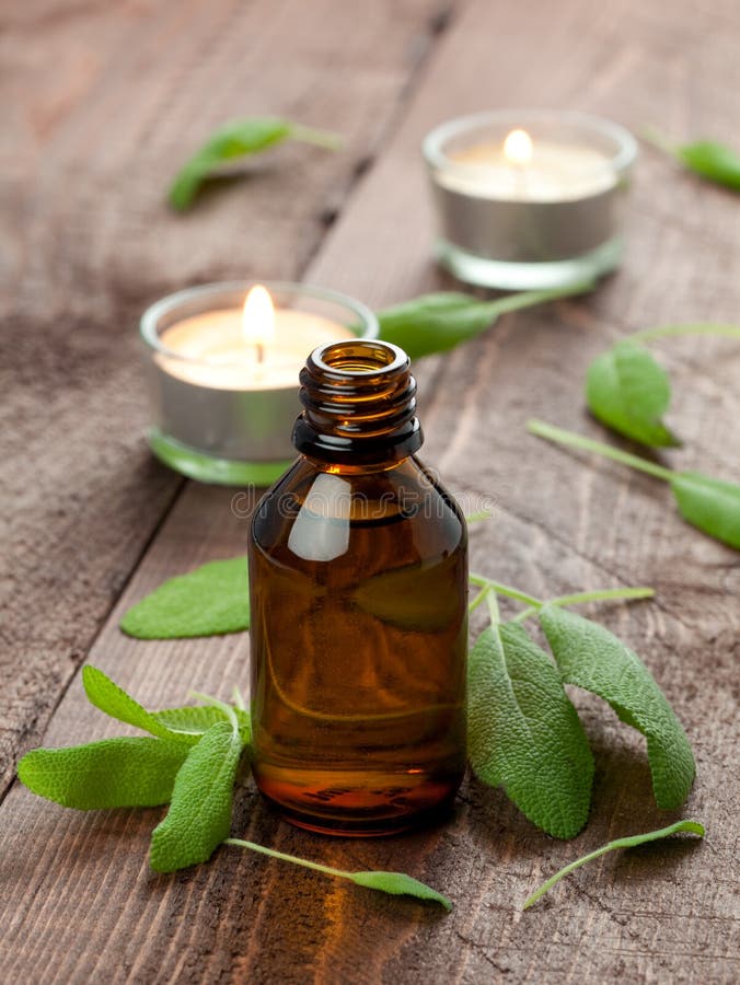 Fresh sage oil with fresh sage on table. Fresh sage oil with fresh sage on table