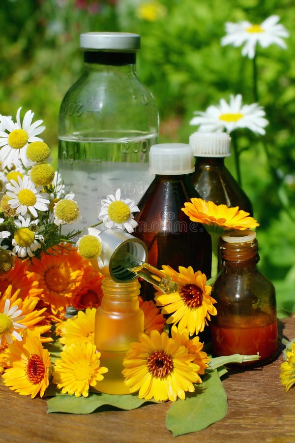 Concept of calendula and camomille flower essential oil and tincture - beauty treatment. Concept of calendula and camomille flower essential oil and tincture - beauty treatment.