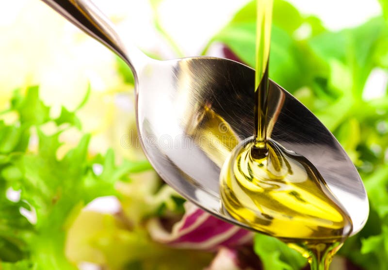 Olive Oil Being Poured into a Spoon and Salad Stock Photo Image of