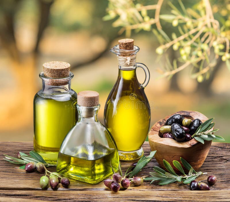 Olive oil and berries are on the wooden table