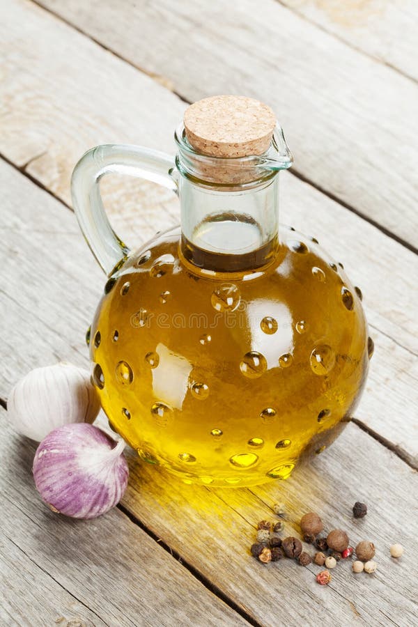 Olive oil bottle with spices royalty free stock photo