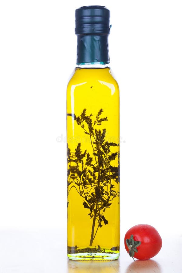 Olive oil in glass bottle and cherry tomato