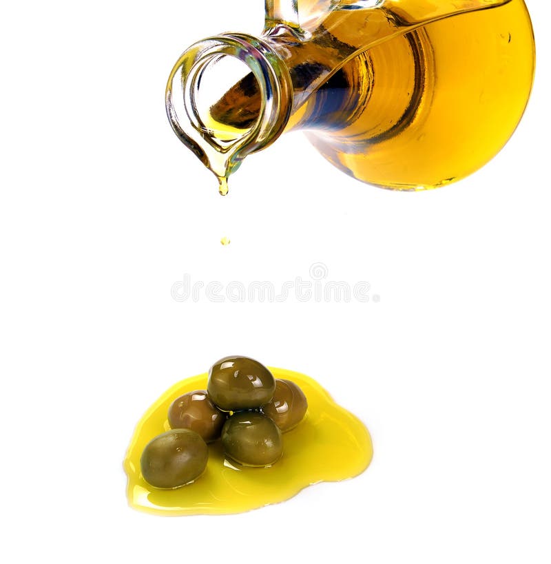 Pouring Olive Oil from a Bottle into a Green Olives Fotografia Stock