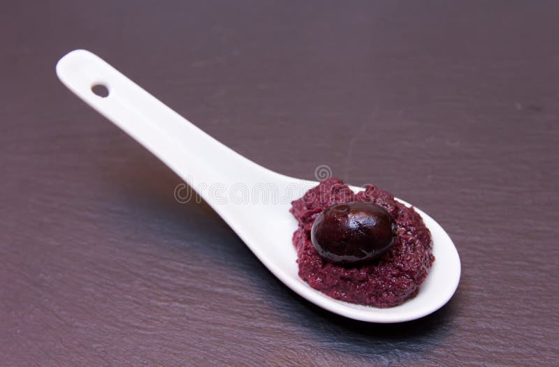 Olive paste on spoon on slate royalty free stock photos Olive paste on spoon on slate royalty free stock photos