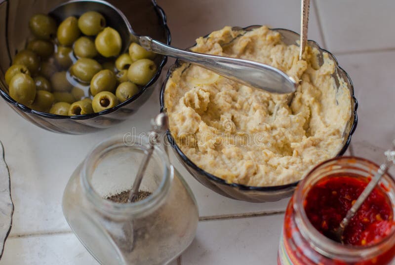 Olives, Hummus, Pepper, Hot Sauce are on the Table Stock Photo Image