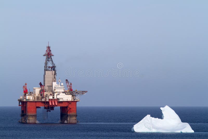 Iceberg next to a offshore oil drilling platform. Iceberg next to a offshore oil drilling platform.