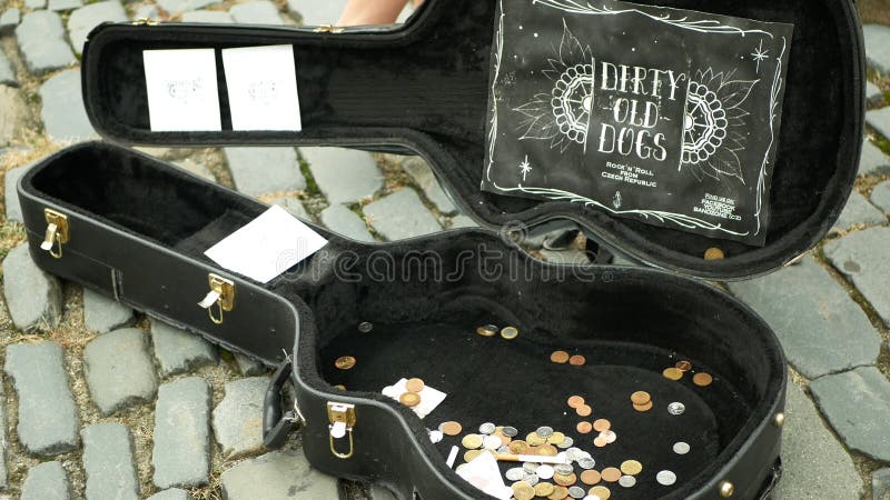 Olomouc, Czech Republic, May 29, 2019: City begging money coins into case, authentic plays music the guitar square