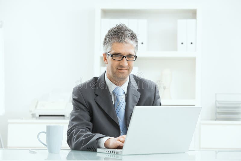 Om de afaceri care lucrează la birou stock image