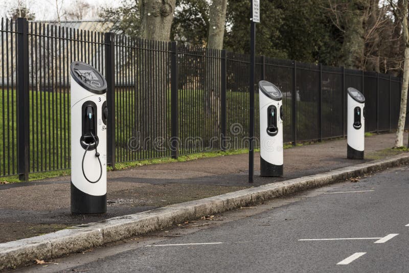 On street electric car charging points / chargers. Measures to improve air quality, reduce noise and particulate pollution. Low emission zone in the city, more environmental friendly. Roadside chargers for lithium ion car batteries. Modern vehicle / automotive or automobile. On street electric car charging points / chargers. Measures to improve air quality, reduce noise and particulate pollution. Low emission zone in the city, more environmental friendly. Roadside chargers for lithium ion car batteries. Modern vehicle / automotive or automobile.