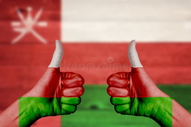 Oman flag painted on female hands thumbs up royalty free stock image