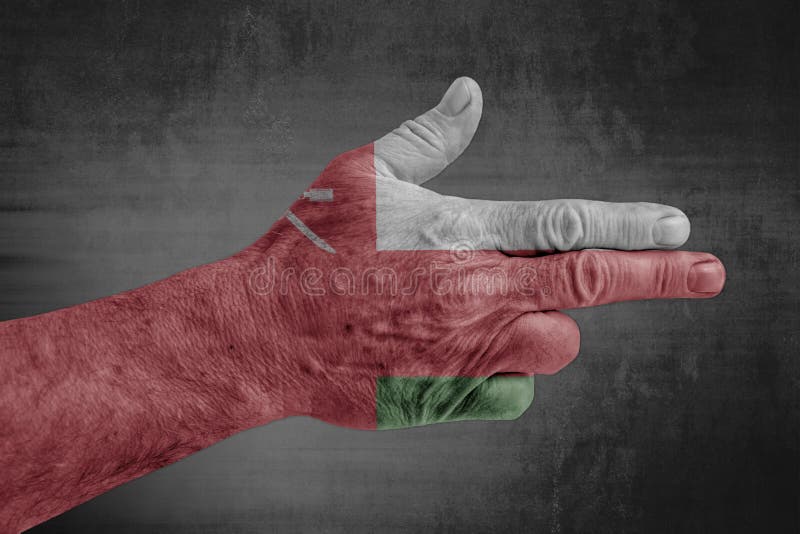 Oman flag painted on male hand like a gun royalty free stock image