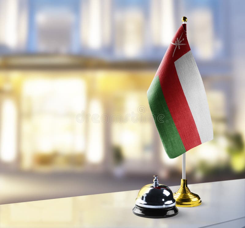 Oman flag on the reception desk in the lobby of the hotel stock photography