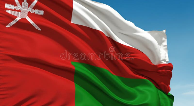 Oman flag waving under blue sky during bright daylight showcasing national pride royalty free stock images