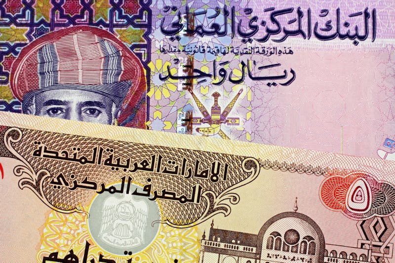 A Mix Of Small Omani Riyal Currency Bills Spread Out On The Table Stock