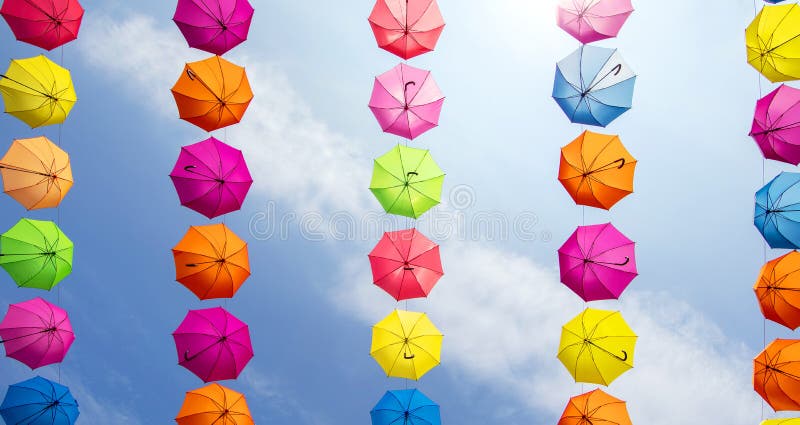 Ombrelli colorati appesi contro il cielo azzurro fotografia stock libera da diritti