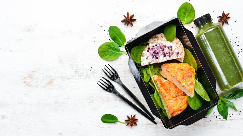 Omelet with vegetables and spinach. Healthy food, restaurant dish delivery. Top view.