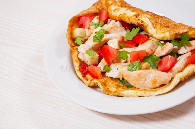 Omelette with slices of chicken breast, cheese and vegetables royalty free stock images Omelette with slices of chicken breast, cheese and vegetables royalty free stock images