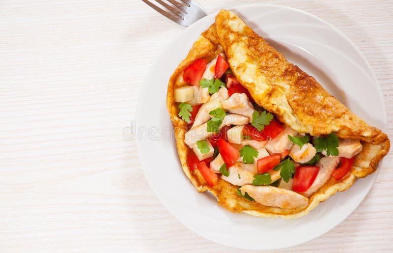Omelette with slices of chicken breast, cheese and vegetables royalty free stock images Omelette with slices of chicken breast, cheese and vegetables royalty free stock images
