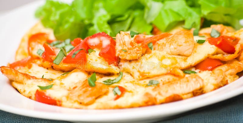 Omelette with slices of chicken breast and vegetables stock images Omelette with slices of chicken breast and vegetables stock images