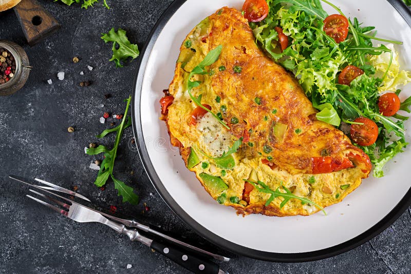 Omelette with Tomatoes, Avocado, Blue Cheese and Green Peas on White ...