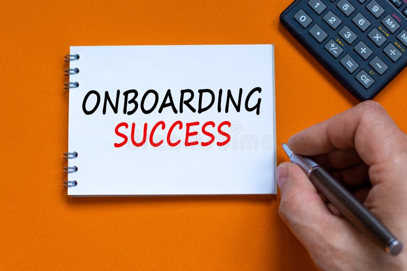 Onboarding success symbol. Businessman writing words Onboarding success on white note. Black calculator. Beautiful orange