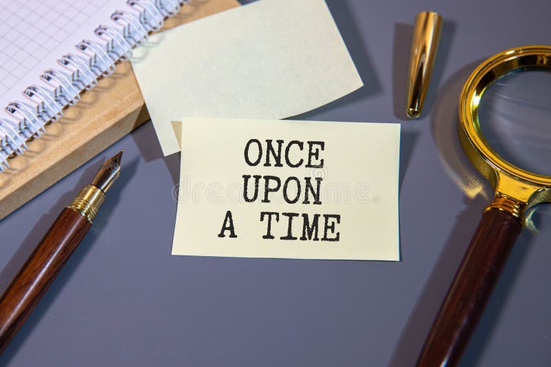 Once upon a time, text on white paper on torn craft paper. royalty free stock photos