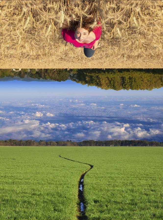 Attractive young teenage white Caucasian female floating above a beautiful field landscape with upside down clouds. Attractive young teenage white Caucasian female floating above a beautiful field landscape with upside down clouds