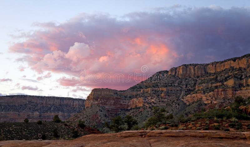 Colorful waves of sunset clouds crest over the North Rim of Grand Canyon. Colorful waves of sunset clouds crest over the North Rim of Grand Canyon.