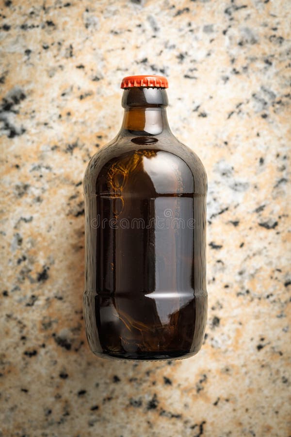 One beer bottle on marble table. Top view royalty free stock photo