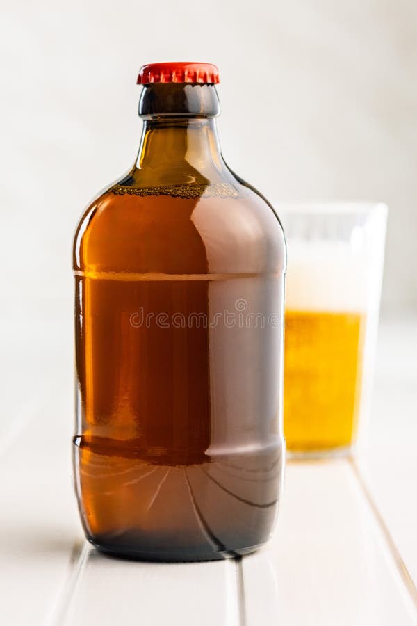 One beer bottle on white table royalty free stock image