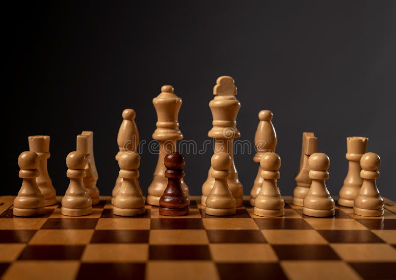 One black pawn unique and different in group of other chess pieces. Concept of diversity royalty free stock image